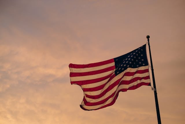 An American flag waving against a warm evening sky brings a respectful and reflective touch to cremations Columbus, OH