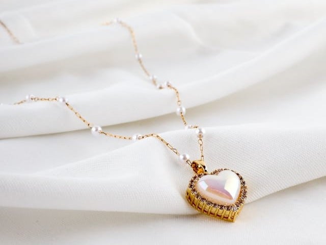 A heart-shaped pendant resting on soft fabric creates a tender and meaningful scene for direct cremation Columbus, OH