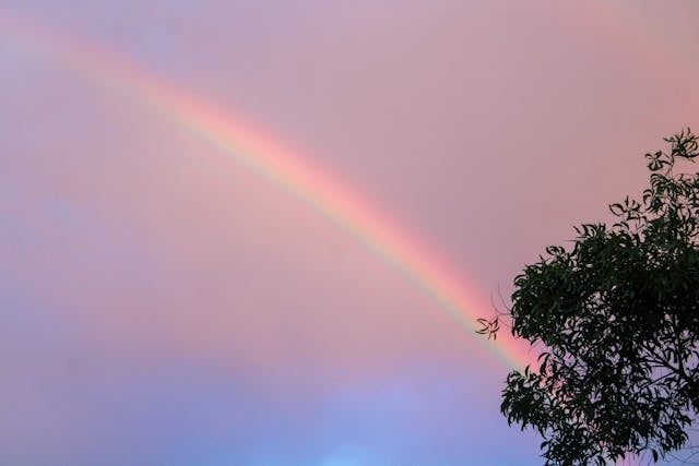 A soft rainbow stretching across the sky adds a hopeful and comforting touch to cremations Columbus, OH