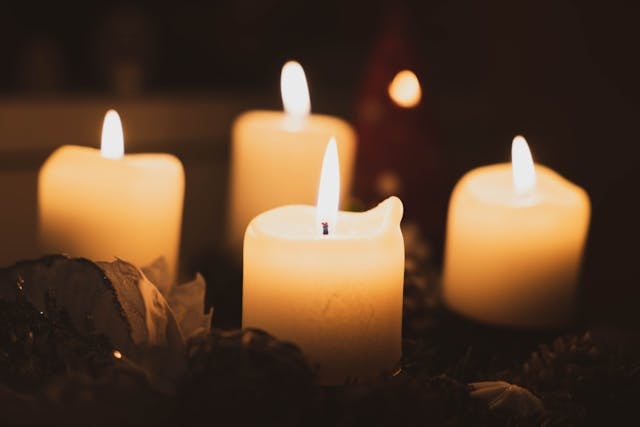 Four soft candlelights creates a warm and reflective tribute for direct cremation Columbus, OH